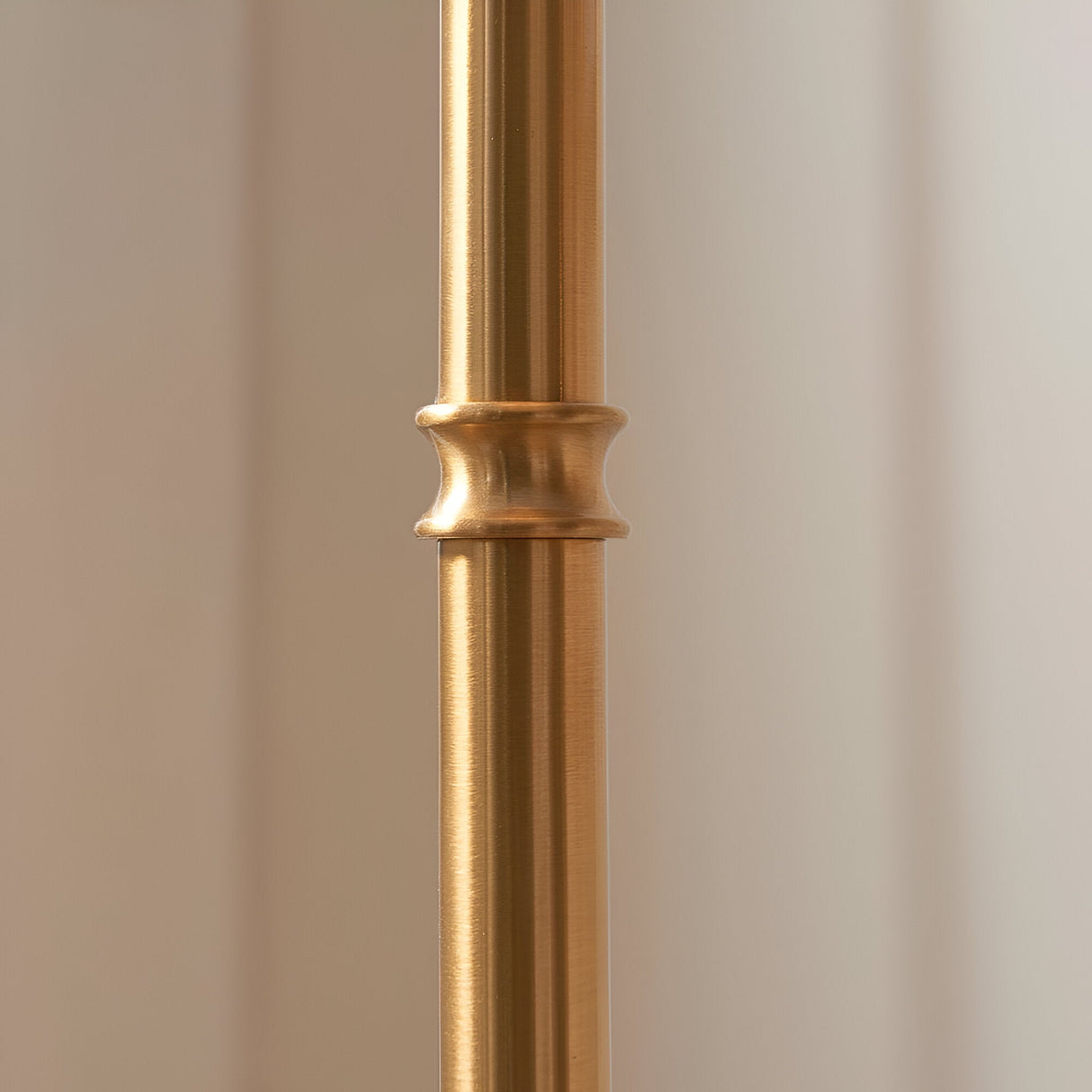 Close-up of the brushed aged brass stem on the Endon Ashstead LED Ivy floor lamp, showing a turned decorative collar detail.
