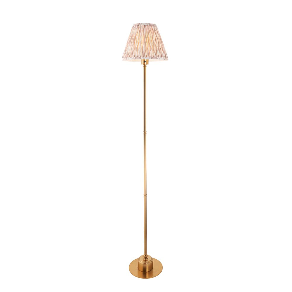 Endon Ashstead LED Ikat floor lamp with a brushed brass stem, round base and 25cm pleated faux silk Ikat shade in natural, on a white background.