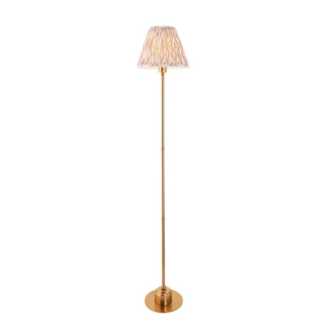 Endon Ashstead LED Ikat floor lamp with a brushed brass stem, round base and 25cm pleated faux silk Ikat shade in natural, on a white background.
