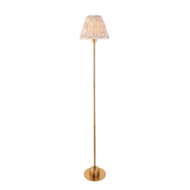 Endon Ashstead LED Ikat floor lamp with a brushed brass stem, round base and 25cm pleated faux silk Ikat shade in natural, on a white background.