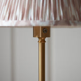Close-up of the Endon Ashstead LED Ikat Floor Lamp showing the brushed brass stem, touch dimmer button, and pleated pink and white Ikat shade.