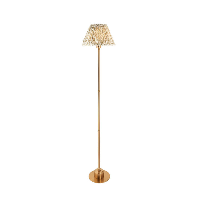 Endon Ashstead LED floor lamp with a brushed brass stem, round base, and pleated leaf-print fabric shade in neutral tones, on a white background.