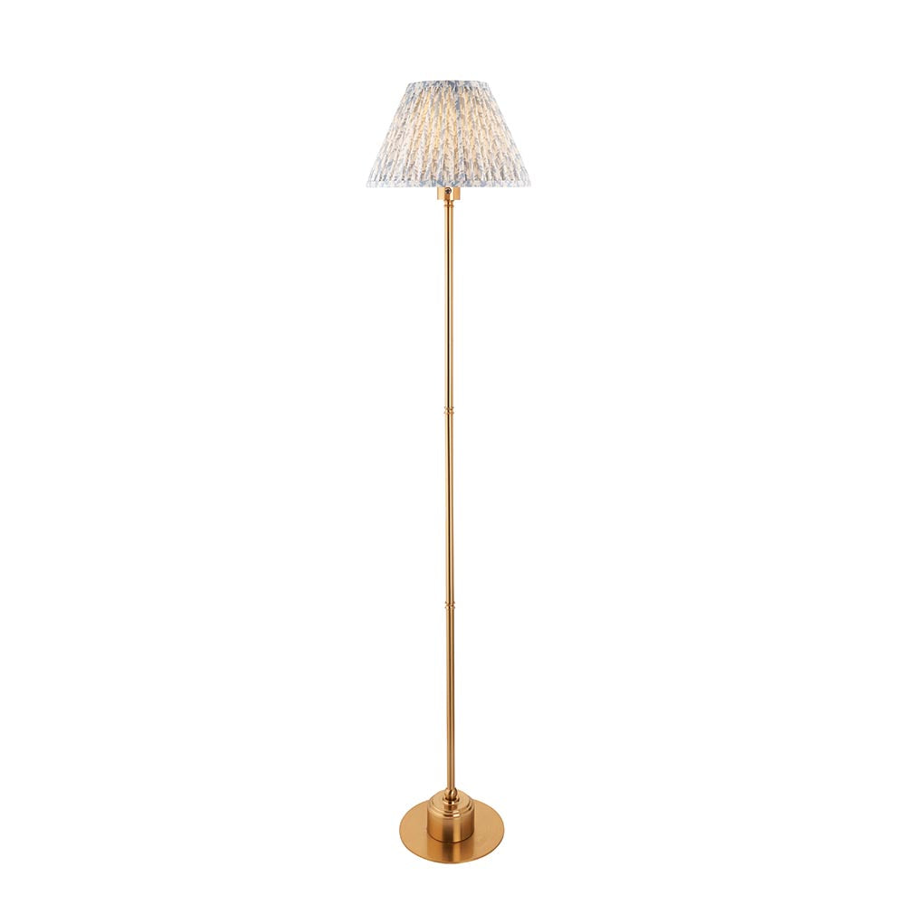 Ashstead LED Leaf Floor Lamp with slim brushed brass stem and pleated white and blue leaf-print fabric shade, on a plain white background.