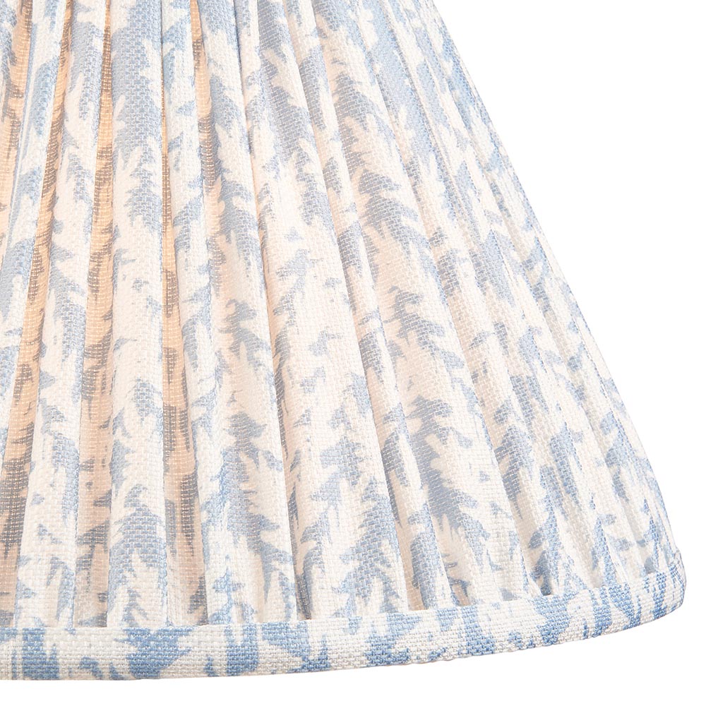 Close-up of the Ashstead LED Floor Lamp's pleated fabric shade in a leaf print pattern with blue and white tones and taped edge trim.