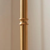 Close-up of the Ashstead LED Leaf Floor Lamp's slim brushed aged brass stem, showing a decorative joint detail against a plain light background.