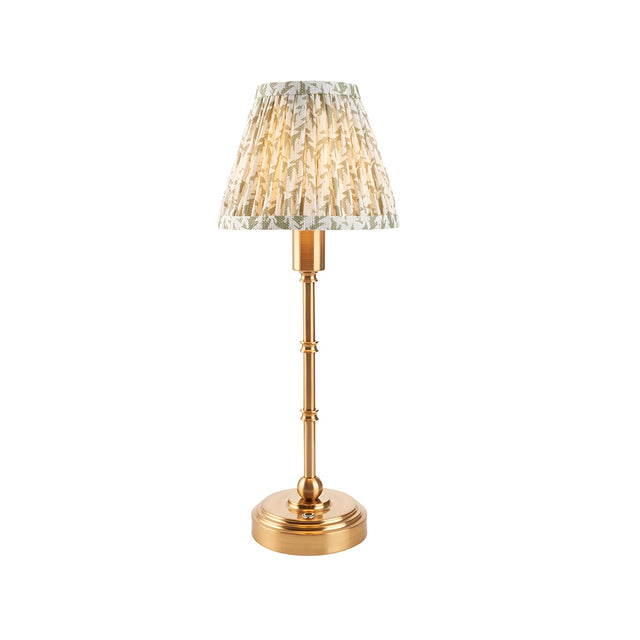 Ashstead LED table lamp with a slender brass stem, round base, and pleated leaf-print shade in white and green, shown on a plain white background.