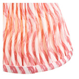 Close-up of the Endon Ashstead table lamp's handmade pleated shade in faux linen with a coral pink and orange rippled wave print.