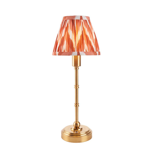 Endon Ashstead LED table lamp with brushed brass stem and pleated apricot zigzag print shade, shown on a plain white background.