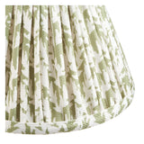 Close-up of the Endon Ashstead LED wall light's pleated shade in digitally printed faux linen with a herb green leaf pattern on white.