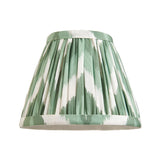Endon Ashstead pleated tapered lamp shade in green and white ikat-style zigzag fabric with ribbon trim, shown on a plain white background.