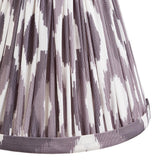 Close-up of the Ashstead LED wall light's pleated Ikat fabric shade in grey and white, showing the tiered folds and trimmed lower edge.
