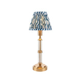 Endon Carlwood LED rechargeable table lamp in brushed brass with clear acrylic stem and blue Ripple pleated faux linen shade, on a white background.