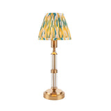 Carlwood LED table lamp with a pleated Ikat-print shade in yellow, teal and white, brass column base and stem, shown on a plain white background.