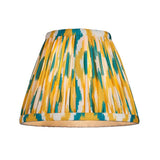 Carlwood LED table lamp shade with pleated yellow, teal and white Ikat-print fabric, shown from the front on a plain white background.