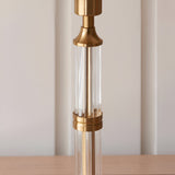 Close-up of the Endon Carlwood rechargeable table lamp's brushed brass column with clear fluted acrylic detailing on a wooden surface.