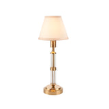 Endon Carlwood LED rechargeable table lamp in brushed brass with clear acrylic column and tapered vintage white fabric shade, on a plain background.
