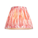 Endon Cranwick LED Ikat table lamp shade in coral pink and white pleated faux silk with digital ikat print, shown on a plain white background.