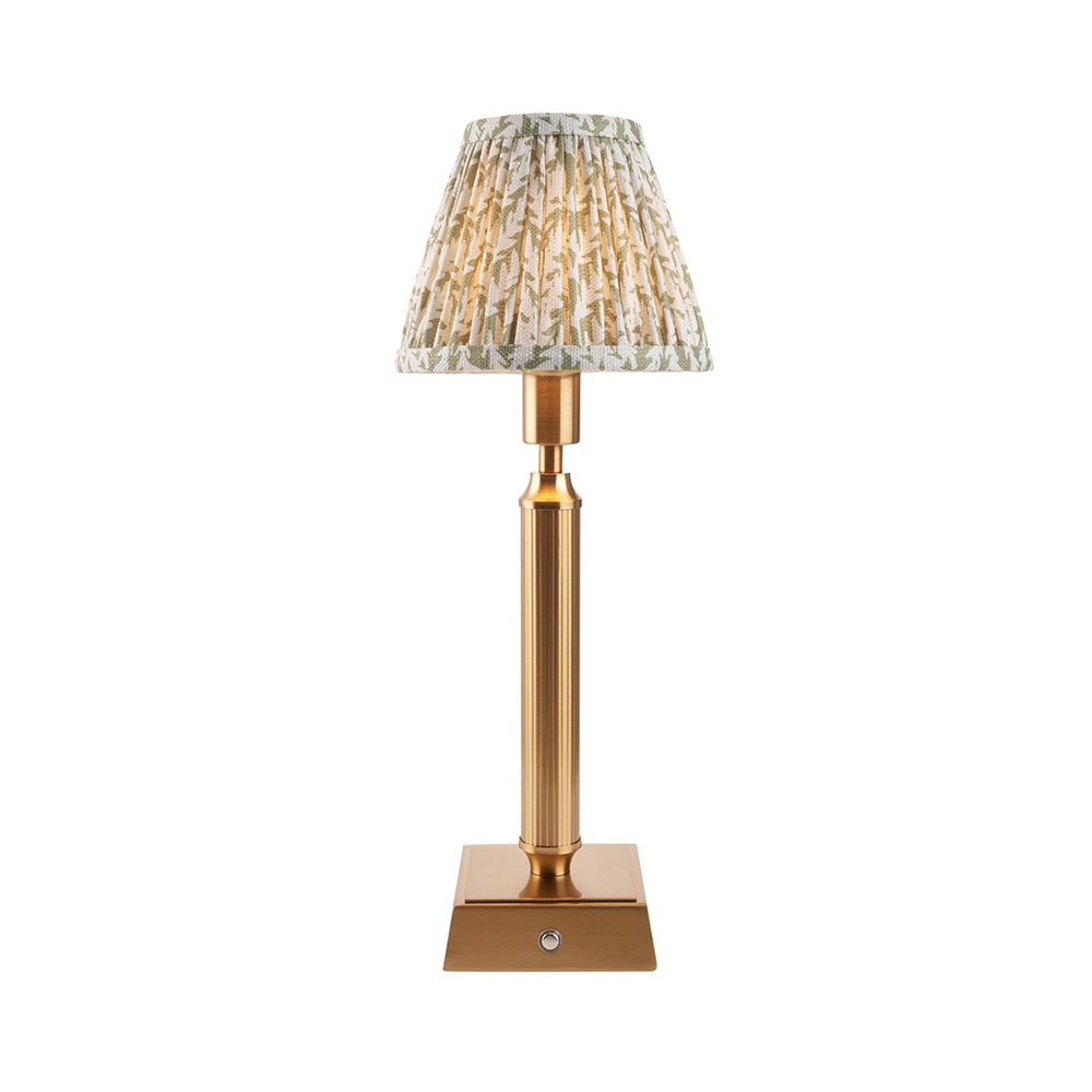 Endon Cranwick LED Leaf table lamp with brushed brass reeded stem, square base, and pleated white and green leaf-print fabric shade on a white background.