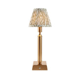 Endon Cranwick LED Leaf table lamp with brushed brass reeded stem, square base, and pleated white and green leaf-print fabric shade on a white background.