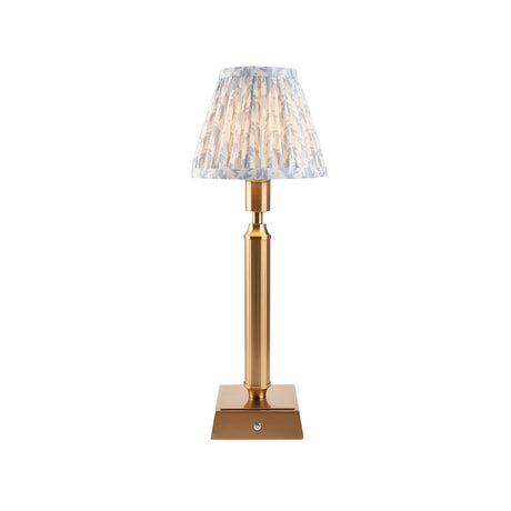 Endon Cranwick LED Leaf table lamp with brushed brass reeded stem, square base and pleated blue and white leaf-print shade on a white background.