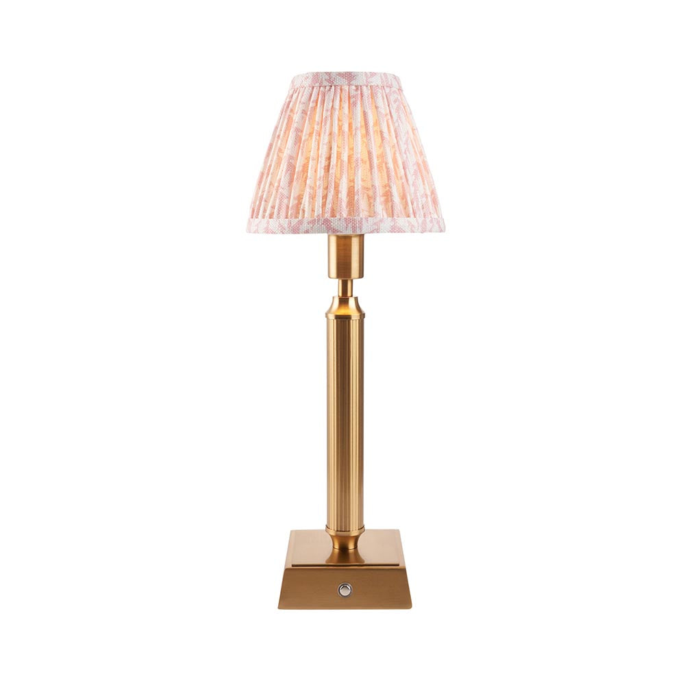 Cranwick LED table lamp with reeded brass stem, square base, touch control, and pleated leaf-print fabric shade on a plain white background.