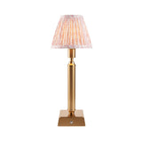 Cranwick LED table lamp with reeded brass stem, square base, touch control, and pleated leaf-print fabric shade on a plain white background.