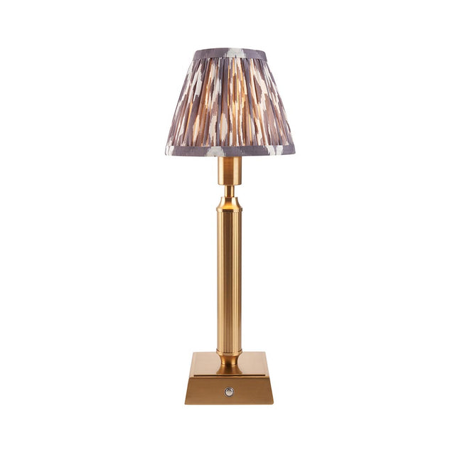 Endon Cranwick LED Ikat table lamp with brushed brass reeded stem, square base and grey and white patterned clip-on shade on a white background.