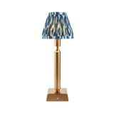 Cranwick LED Ikat Table Lamp with reeded brass stem, square base and blue, white and gold patterned fabric shade, shown on a plain white background.