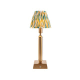 Cranwick LED table lamp with reeded brass stem, square base, touch dimmer and pleated yellow, teal and white Ikat-print fabric shade.