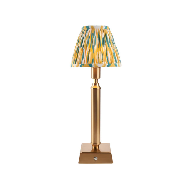 Cranwick LED table lamp with reeded brass stem, square base, touch dimmer and pleated yellow, teal and white Ikat-print fabric shade.