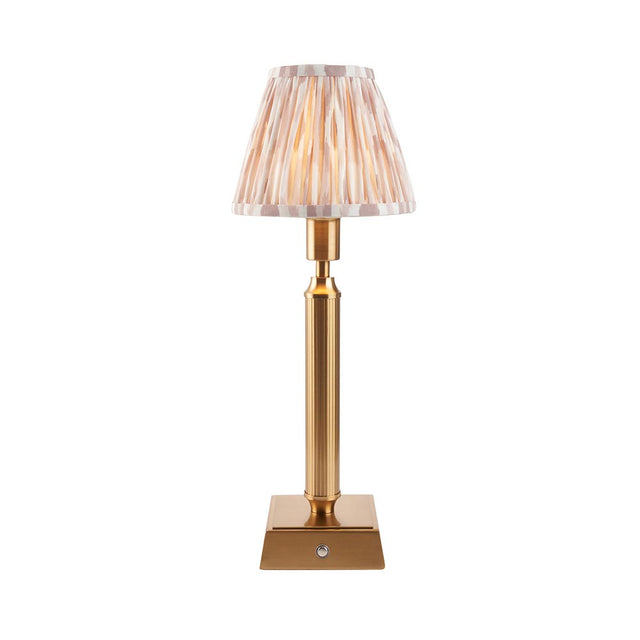Cranwick LED Ikat table lamp with reeded brass stem, square base, touch dimmer, and pleated ivory-striped fabric shade on a plain white background.