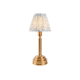 Danebourne LED table lamp with a brass stepped base, touch dimmer, and pleated white and blue leaf-patterned fabric shade.