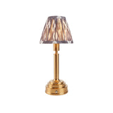 Endon Danebourne LED Ikat table lamp with brushed brass stepped base and grey, white and cream patterned faux silk clip-on shade, on a white background.