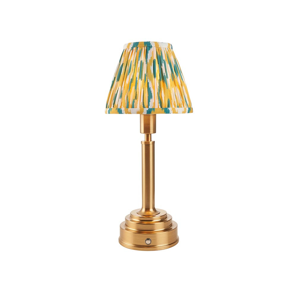 Endon Danebourne LED Ikat table lamp with brushed brass stepped base and clip-on pleated shade in yellow, teal and white, on a plain background.