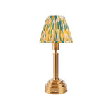 Endon Danebourne LED Ikat table lamp with brushed brass stepped base and clip-on pleated shade in yellow, teal and white, on a plain background.