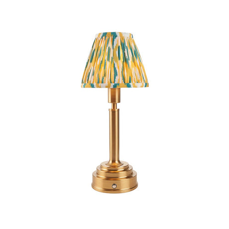 Endon Danebourne LED Ikat table lamp with brushed brass stepped base and clip-on pleated shade in yellow, teal and white, on a plain background.