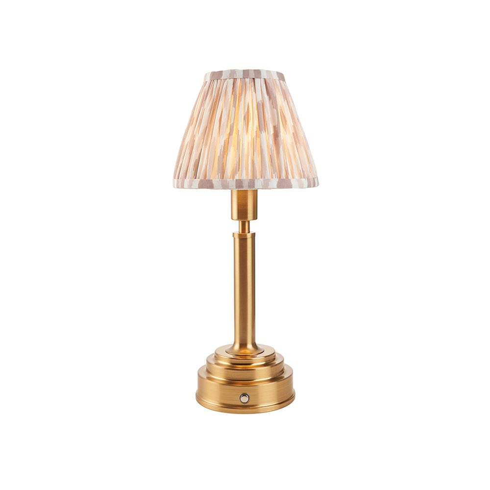 Danebourne LED Ikat table lamp with brass stepped base and pleated white and natural patterned fabric shade, shown against a plain white background.