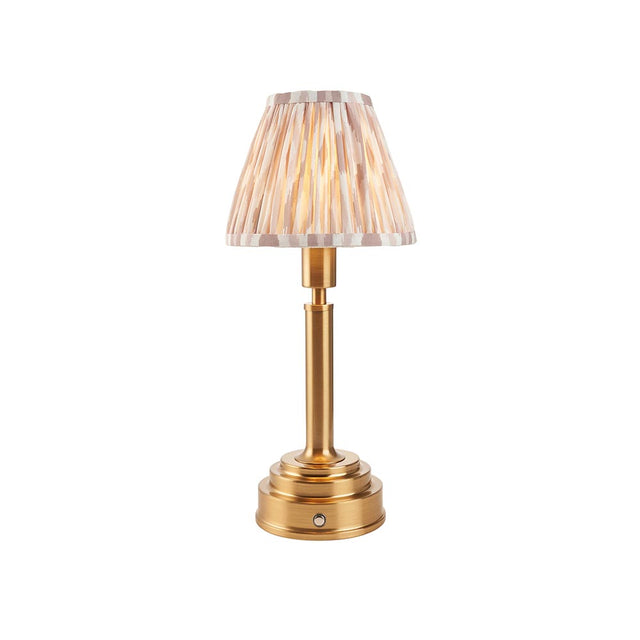 Danebourne LED Ikat table lamp with brass stepped base and pleated white and natural patterned fabric shade, shown against a plain white background.
