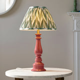 Endon Carlworth table lamp with turned glossy pink resin spindle base and pleated green zigzag print shade, on a marble side table.