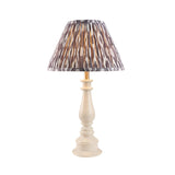 Carlworth Ikat Table Lamp with turned almond white resin spindle base and pleated grey patterned fabric shade, shown on a plain white background.