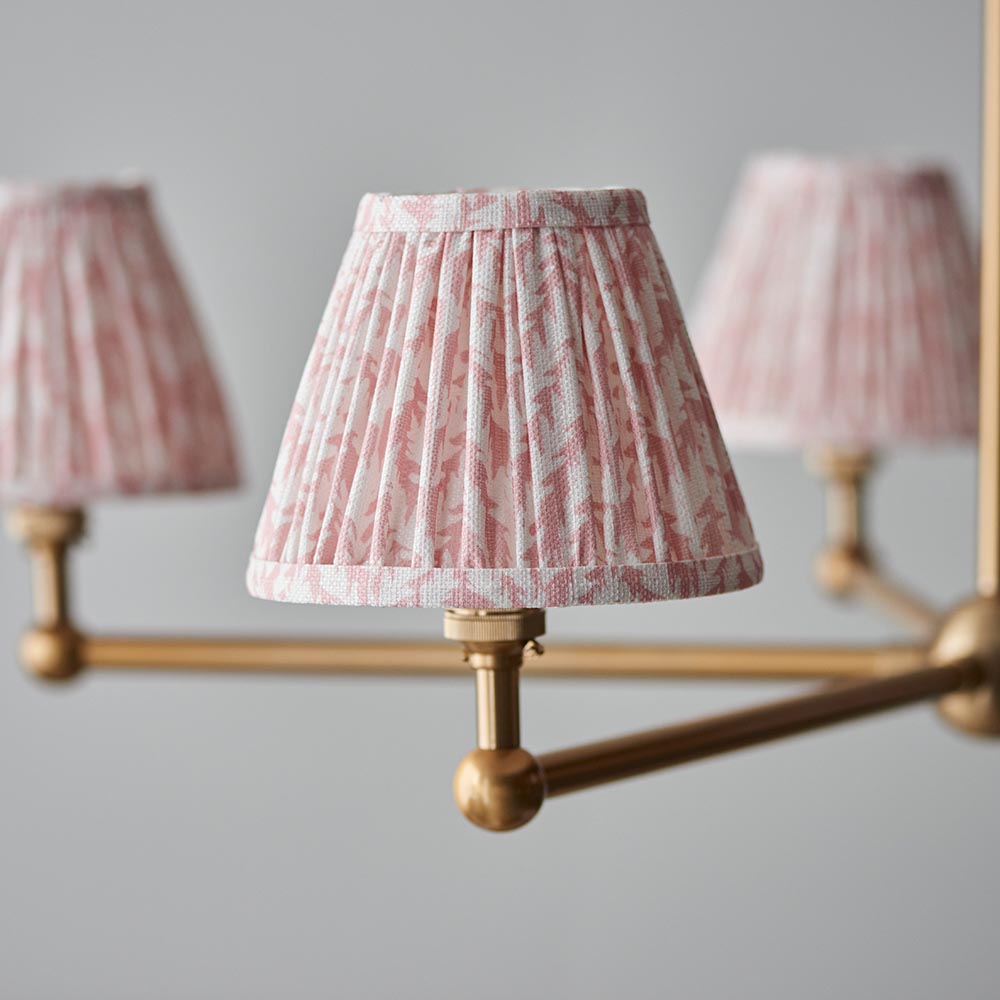 Cliffleigh Leaf 5-Light Pendant with pleated pink floral fabric shades on brushed brass arms and ball joint fittings, shown against a grey background.