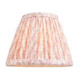Cliffleigh Leaf tapered fabric lamp shade in pink and cream leaf print with pleated sides and brass-toned trim, shown against a plain white background.