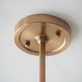 Close-up of the Cliffleigh Ikat pendant's brushed brass ceiling rose with adjustable stem and grey fabric flex against a plain white ceiling.