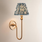 Endon Cliffleigh wall light in brushed aged brass with a tall curved arm and pleated marlin blue faux linen shade in a ripple design.