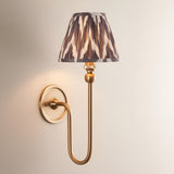 Endon Cliffleigh Zigzag wall light in brushed aged brass with a slim curved arm and pleated pearl grey zigzag print tapered shade.
