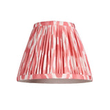 Endon Cliffleigh tapered pleated wall light shade in coral pink and white Ikat printed faux silk, shown on a plain white background.