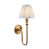 Endon Cliffleigh Leaf wall light in brushed brass with a curved arm and pleated blue leaf-print faux linen tapered shade, on a white background.