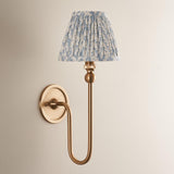 Endon Cliffleigh Leaf Wall Light II in brushed brass with a curved arm and pleated blue leaf-print fabric shade, mounted on a pale wall.