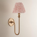 Endon Cliffleigh Leaf wall light in brushed brass with curved arm, round backplate, and pleated pink leaf-print faux linen tapered shade.