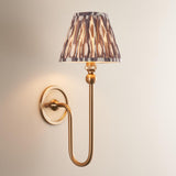 Cliffleigh Ikat Wall Light with brushed aged brass long-arm base and pleated tapered shade in grey and brown patterned fabric.